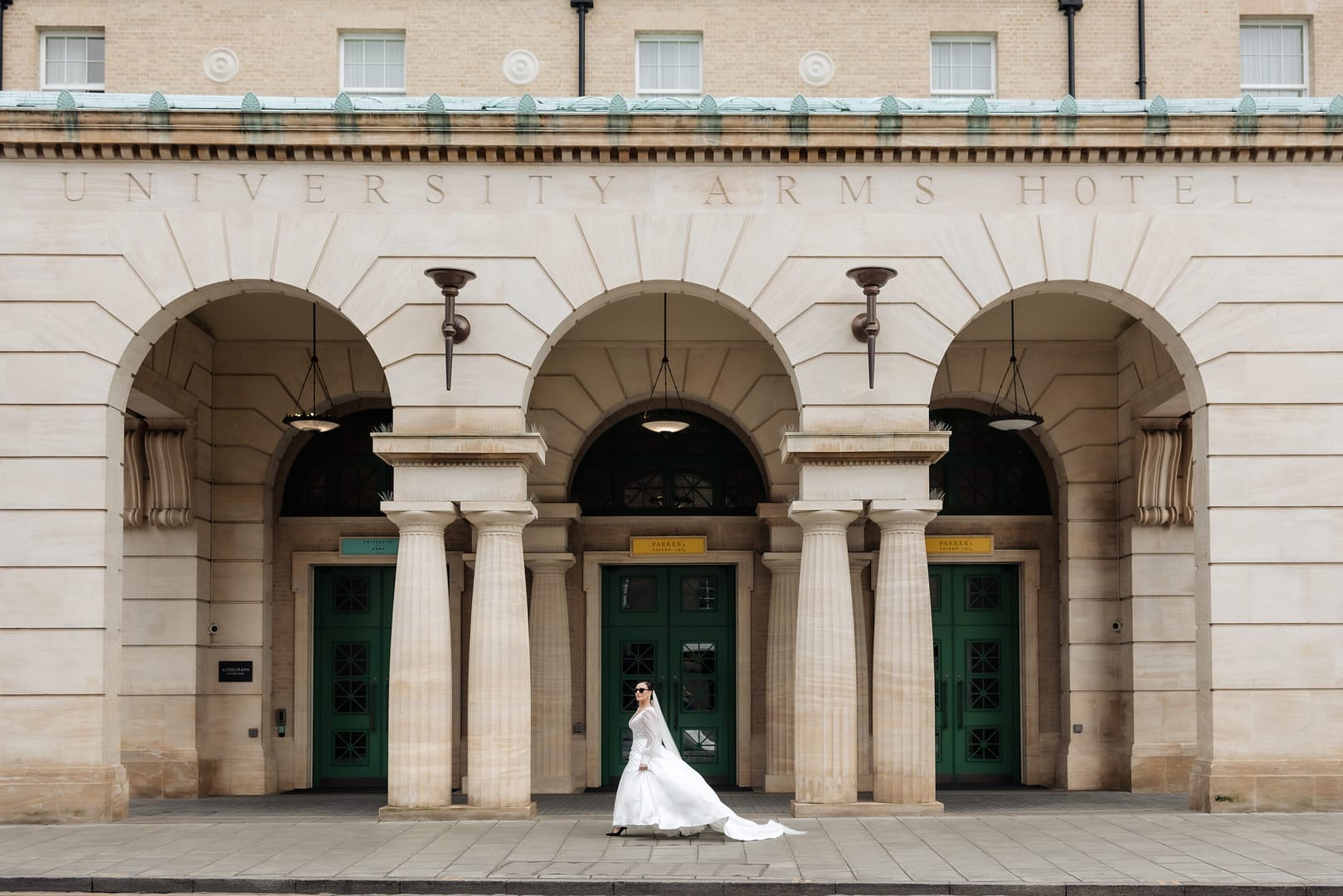 Newlyweds walking through London streets after their wedding, captured by editorial London wedding photographer