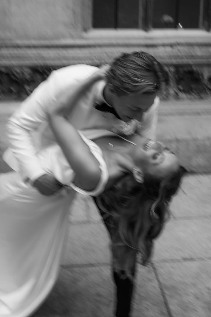 Trendy blurry photo of bride and groom having fun after their London wedding