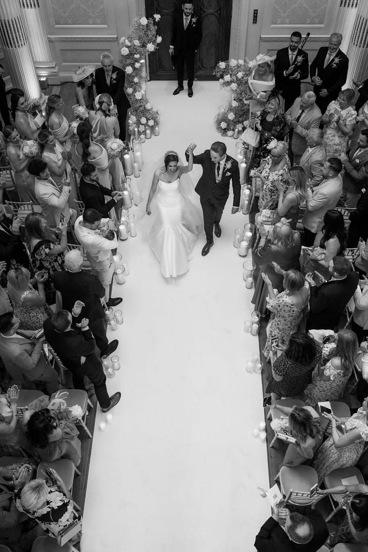 Bride and groom holding hands during London wedding ceremony, captured by London wedding photographer Elizabeth Jayne